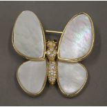 An 18 K gold mother-of-pearl and diamond set butterfly brooch. 3.5 cm wide.