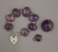 An amethyst bracelet with associated padlock approximately 16 cm long,