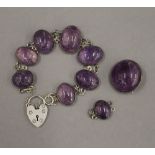 An amethyst bracelet with associated padlock approximately 16 cm long,