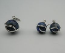 A pair of silver lapis earrings, together with matching pendant. The latter 3 cm high.