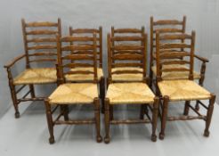 A set of eight rush seated ladder back chairs. The carvers 57.5 cm wide.