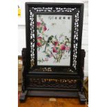 A Chinese porcelain and carved wooden table screen