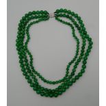 An 18 ct white gold jade and diamond necklace. Approximately 54 cm long.