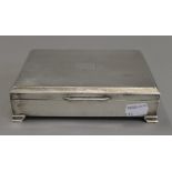An Art Deco silver cigarette box. 16.5 cm wide. 22.2 troy ounces total weight.