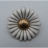 A Danish Marguerite silver gilt and enamel daisy brooch/pendant by Anton Michelsen. 5 cm diameter.