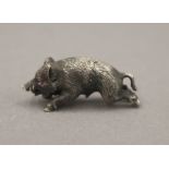A small silver model of a boar, with gem set eyes, bearing Russian marks. 3.5 cm long.