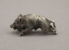 A small silver model of a boar, with gem set eyes, bearing Russian marks. 3.5 cm long.