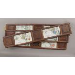 Four Chinese porcelain plaques, housed in wooden frames. The largest 96 cm high.