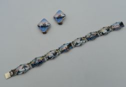 A Norwegian silver and enamel bracelet, together with a matching pair of ear clips. The former 17.