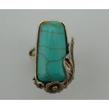 A silver turquoise ring.