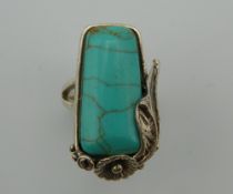 A silver turquoise ring.