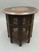 An Indian hardwood folding table. 52 cm diameter.