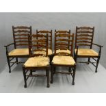 A set of six rush seated ladder back chairs. The carvers 59 cm wide.
