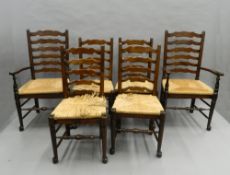 A set of six rush seated ladder back chairs. The carvers 59 cm wide.