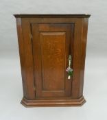 A Georgian oak corner cupboard. 105 cm high.