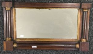 A Regency gilt heightened rosewood over mantle mirror. 67 cm wide.