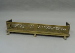 A brass fender. 121 cm wide x 22 cm high x 34 cm deep.