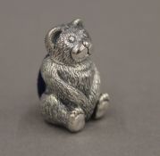 A silver pin cushion formed as a teddy bear