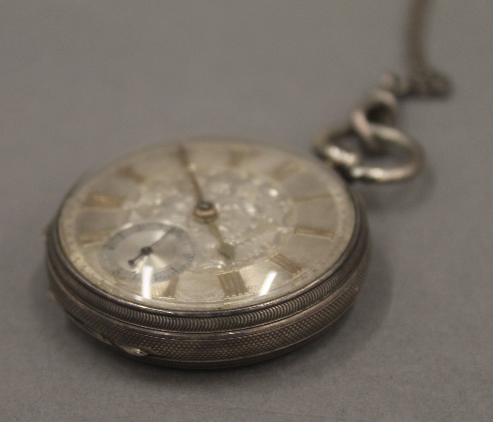 Two 19th century silver pocket watches on chains and a brass pocket watch case. - Image 12 of 12