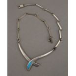 A silver and turquoise necklace. 38 cm long. 40 grammes total weight.