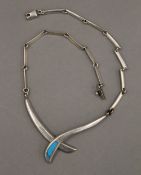 A silver and turquoise necklace. 38 cm long. 40 grammes total weight.