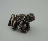 A model of a frog, bearing Russian marks. 4.5 cm long.