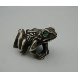 A model of a frog, bearing Russian marks. 4.5 cm long.