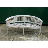 A curved wooden garden bench