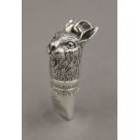 A silver whistle formed as a rabbit's head. 4 cm high.