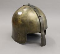 A brass re-enactment helmet. 22.5 cm high.