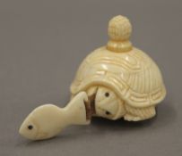 A bone tortoise tape measure. 3.5 cm high.