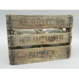 Two cider flagons, in a wooden crate. 37 cm wide.