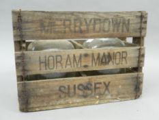 Two cider flagons, in a wooden crate. 37 cm wide.