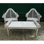 A pair of Lutyens style wooden garden chairs and a table