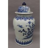 A Chinese porcelain blue and white vase and cover. 60 cm high.