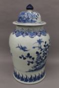 A Chinese porcelain blue and white vase and cover. 60 cm high.