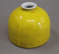 A Chinese yellow porcelain brush pot. 8 cm high.