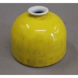 A Chinese yellow porcelain brush pot. 8 cm high.