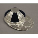 A silver jockey's cap pin cushion. 3.5 cm wide.