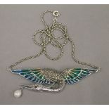 A silver plique-a-jour bird pendant on chain. The pendant 7.5 cm wide.