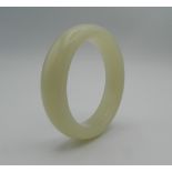 A white jade bangle. 8 cm diameter.