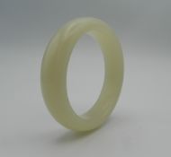 A white jade bangle. 8 cm diameter.