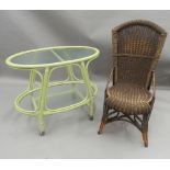 An oval glass green painted two-tier tea trolley and a wicker chair. The former 80 cm long.