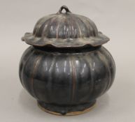 A Chinese brown glazed lidded tureen formed as a pumpkin. 22 cm high.