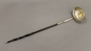 A Georgian coin set unmarked silver baleen toddy ladle. 37 cm long.