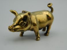 A brass vesta in the form of a pig. 4.5 cm long.