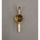 A 9 ct gold and citrine pocket watch fob key. 3 cm long. 2.2 grammes total weight.