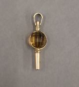 A 9 ct gold and citrine pocket watch fob key. 3 cm long. 2.2 grammes total weight.