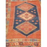 A red ground rug. 172 cm x 120 cm.