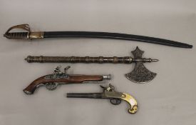 Two replica guns, an axe and a sword. The latter 89 cm long.